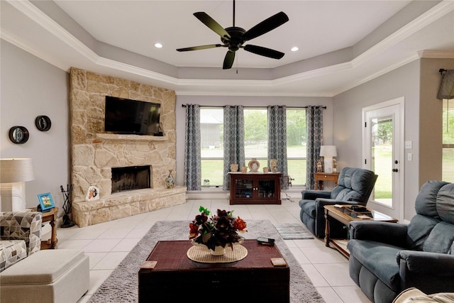140 Pine Rd, Poolville, TX 76487 - living room with light tile patterned floors, a fireplace, a tray ceiling, ceiling fan, and crown molding