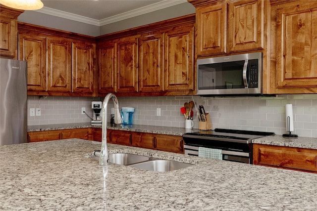 140 Pine Rd, Poolville, TX 76487 - kitchen featuring appliances with stainless steel finishes, a sink, brown cabinets, and crown molding