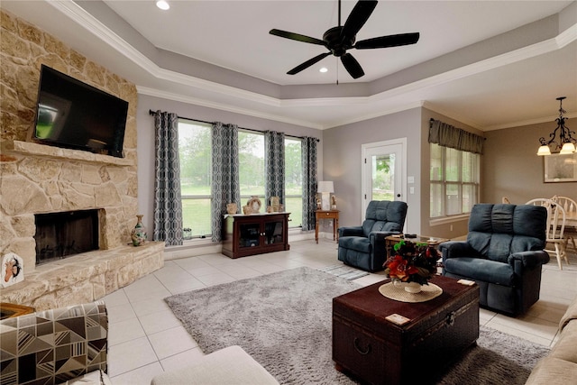 140 Pine Rd, Poolville, TX 76487 - tiled living area featuring a tray ceiling, a ceiling fan, a chandelier, a stone fireplace, and crown molding