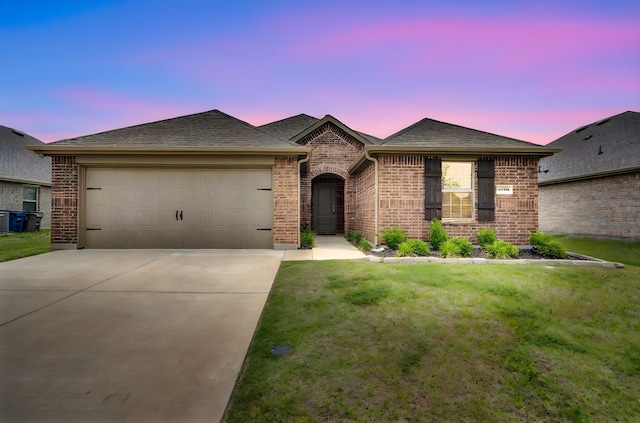 1403 Blossom Court Dr, Princeton, TX 75407 - french country inspired facade featuring brick siding, a garage, concrete driveway, a lawn, and roof with shingles