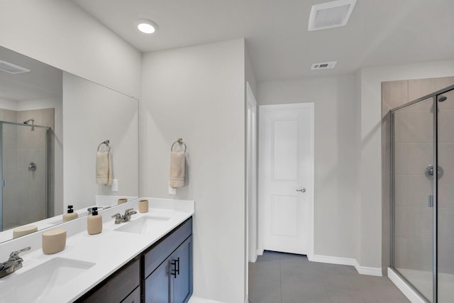 1403 Blossom Court Dr, Princeton, TX 75407 - bathroom with a stall shower, tile patterned flooring, baseboards, and double vanity