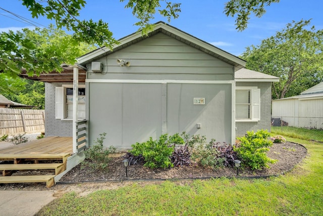 121 Chowning Dr, Desoto, TX 75115 - view of home's exterior featuring fence, brick siding, and a wooden deck