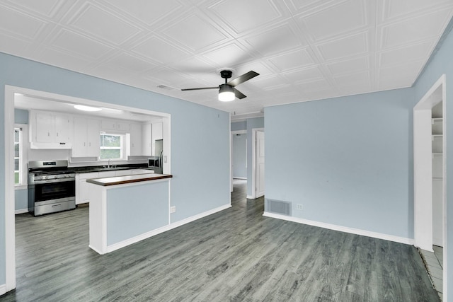 121 Chowning Dr, Desoto, TX 75115 - kitchen featuring stainless steel range with gas cooktop, a sink, open floor plan, white cabinets, and dark countertops