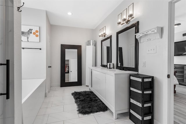 203 Mcelroy St, Southmayd, TX 76273 - full bathroom featuring marble finish floors, a bathtub, recessed lighting, vanity, and baseboards