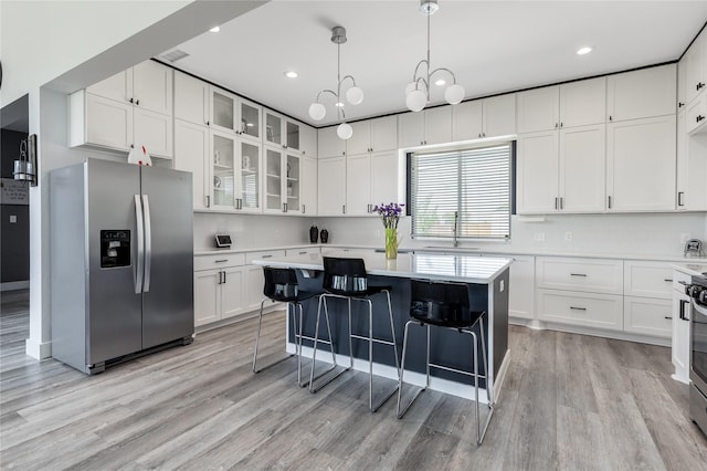 203 Mcelroy St, Southmayd, TX 76273 - kitchen with stainless steel fridge, a sink, light countertops, light wood finished floors, and white cabinets