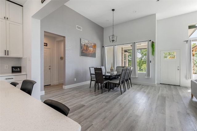 203 Mcelroy St, Southmayd, TX 76273 - dining area featuring a high ceiling, baseboards, light wood-style flooring, and a chandelier