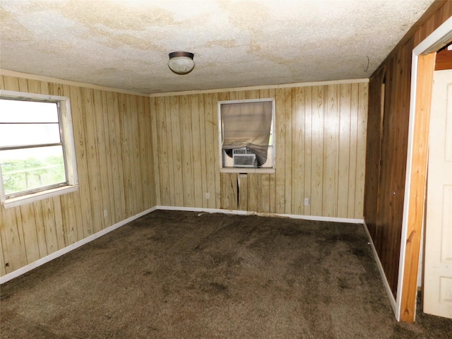 1819 Grady Rd, Hawk Cove, TX 75474 - unfurnished room with cooling unit, a textured ceiling, dark colored carpet, and wooden walls