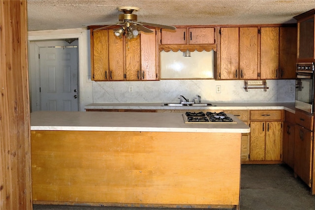 1819 Grady Rd, Hawk Cove, TX 75474 - kitchen with oven, gas stovetop, ceiling fan, a sink, and light countertops