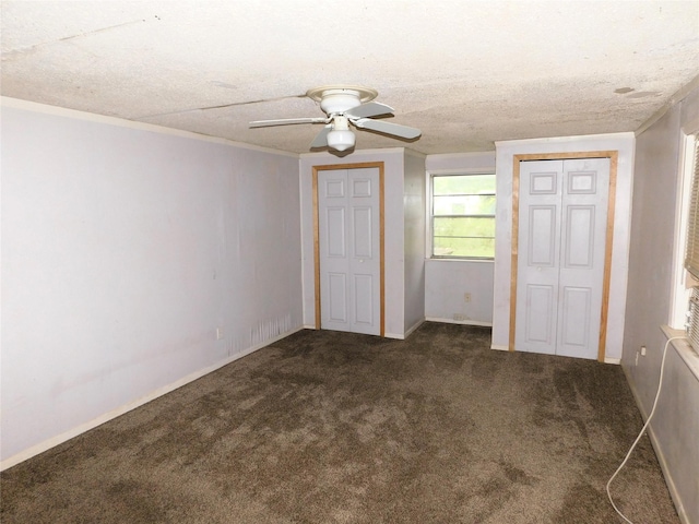 1819 Grady Rd, Hawk Cove, TX 75474 - unfurnished bedroom featuring two closets, carpet floors, ceiling fan, baseboards, and a textured ceiling