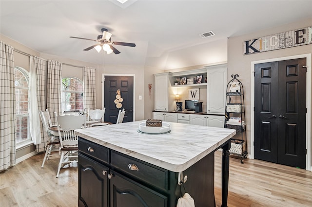 2630 Argyle Shore Dr, Rockwall, TX 75087 - kitchen featuring light wood-style flooring, a ceiling fan, open shelves, white cabinets, and a center island