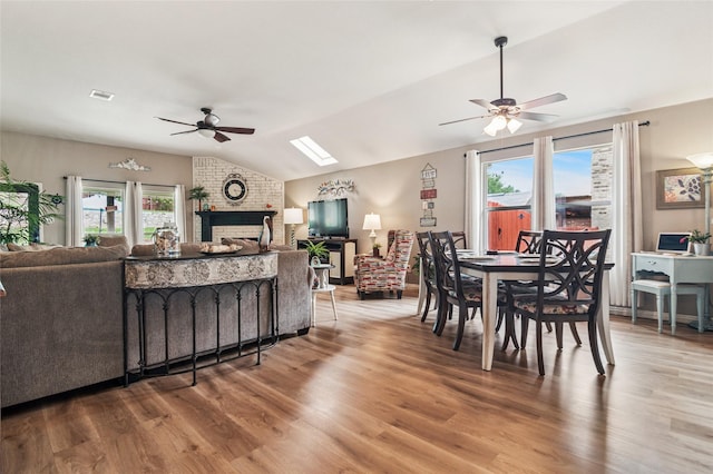 2630 Argyle Shore Dr, Rockwall, TX 75087 - dining area with ceiling fan, lofted ceiling, wood finished floors, and a fireplace