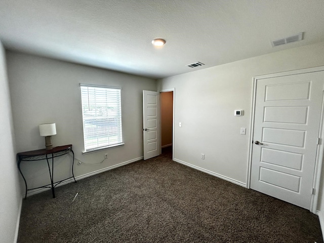 7425 Bledington Ln, Mckinney, TX 75071 - unfurnished bedroom with dark colored carpet and baseboards
