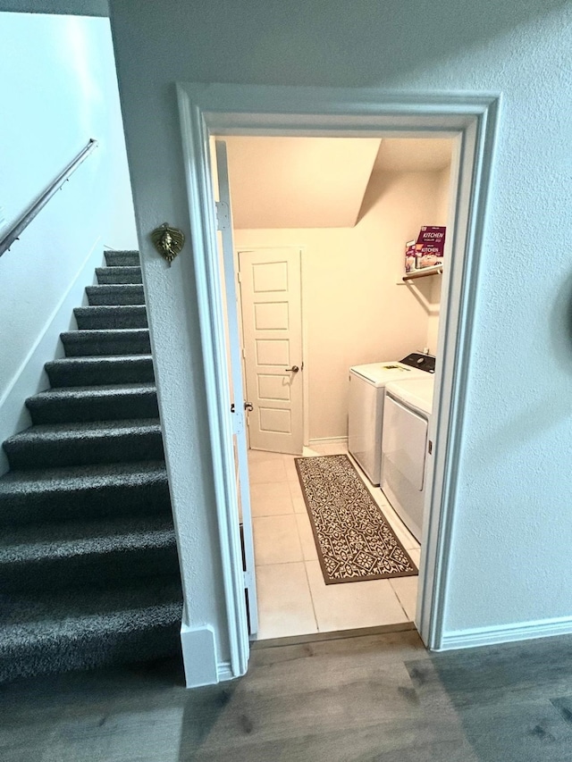7425 Bledington Ln, Mckinney, TX 75071 - stairs featuring washer and dryer, tile patterned floors, and baseboards