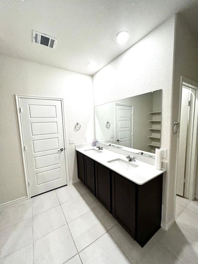 7425 Bledington Ln, Mckinney, TX 75071 - full bath featuring double vanity, tile patterned floors, and baseboards
