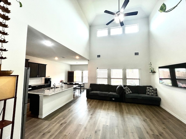 7425 Bledington Ln, Mckinney, TX 75071 - living room featuring ceiling fan, wood finished floors, high vaulted ceiling, baseboards, and recessed lighting