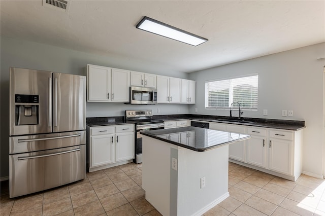8537 Star Thistle Dr, Fort Worth, TX 76179 - kitchen with stainless steel appliances, a sink, white cabinetry, and light tile patterned flooring