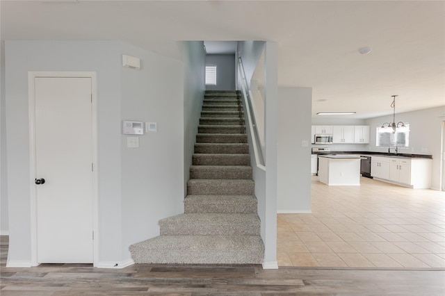 8537 Star Thistle Dr, Fort Worth, TX 76179 - staircase with a chandelier, baseboards, and wood finished floors