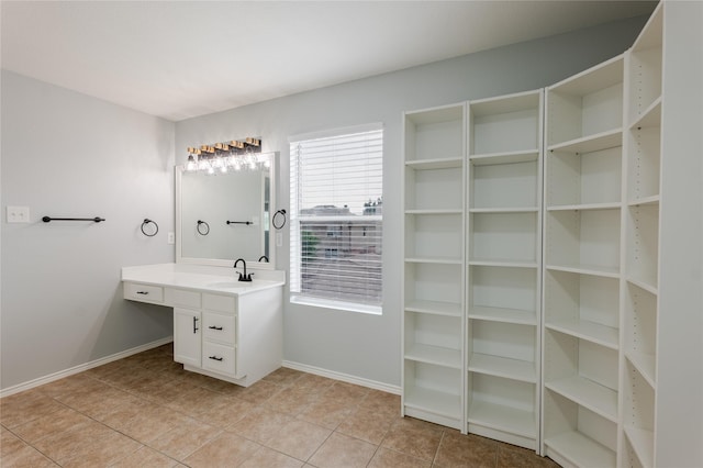 8537 Star Thistle Dr, Fort Worth, TX 76179 - bathroom with tile patterned flooring, baseboards, vanity, and a spacious closet