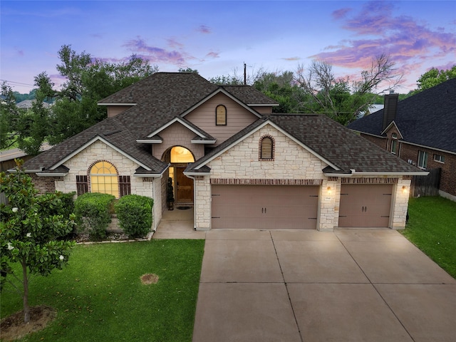 5541 Wisdom Ct, Waco, TX 76708 - french country inspired facade with a shingled roof, concrete driveway, stone siding, and an attached garage
