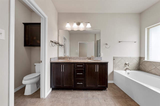 5541 Wisdom Ct, Waco, TX 76708 - full bath featuring tile patterned floors, toilet, double vanity, a garden tub, and baseboards