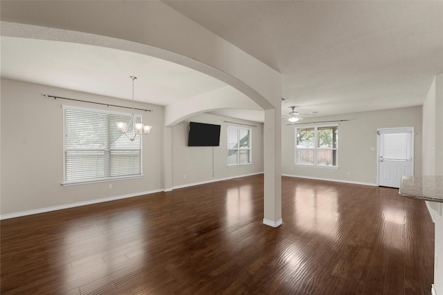 5541 Wisdom Ct, Waco, TX 76708 - unfurnished living room featuring a ceiling fan, a chandelier, dark wood-style floors, and baseboards