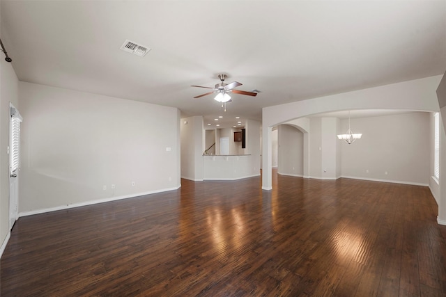 5541 Wisdom Ct, Waco, TX 76708 - unfurnished living room with a ceiling fan, a chandelier, dark wood finished floors, arched walkways, and baseboards