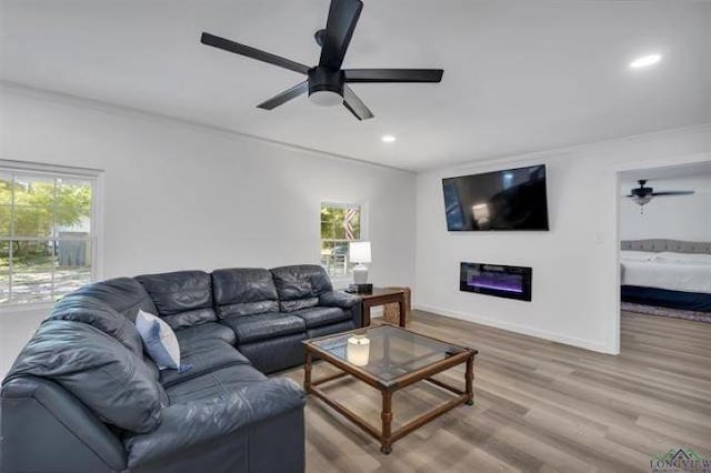 228 Stuart Dr, Karnack, TX 75661 - living area with ceiling fan, healthy amount of natural light, recessed lighting, wood finished floors, and baseboards