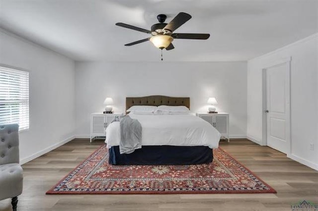 228 Stuart Dr, Karnack, TX 75661 - bedroom featuring wood finished floors, baseboards, and a ceiling fan