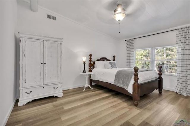 228 Stuart Dr, Karnack, TX 75661 - bedroom with light wood-style floors, baseboards, crown molding, and a ceiling fan