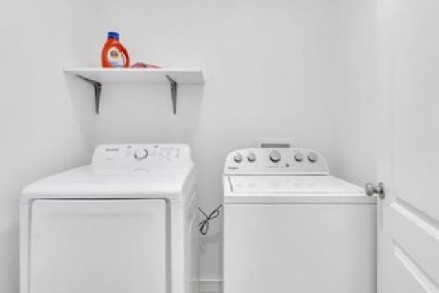 228 Stuart Dr, Karnack, TX 75661 - laundry room featuring washing machine and dryer