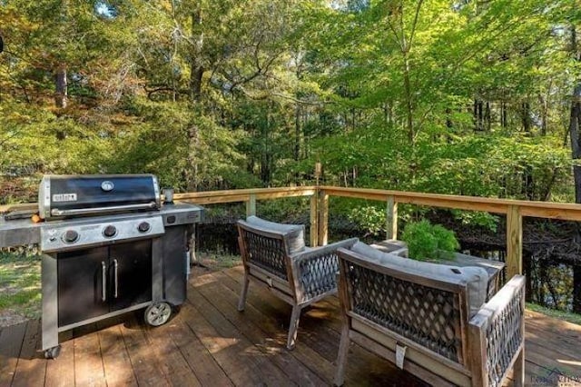 228 Stuart Dr, Karnack, TX 75661 - wooden deck featuring area for grilling, a view of trees, and outdoor lounge area