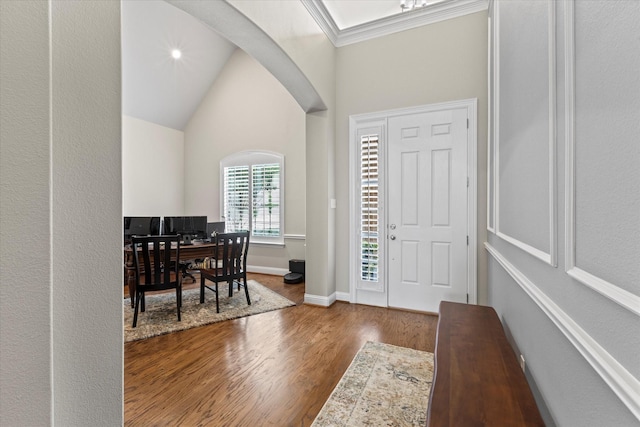 5581 Travis Dr, Frisco, TX 75034 - foyer with wood finished floors, arched walkways, baseboards, and ornamental molding