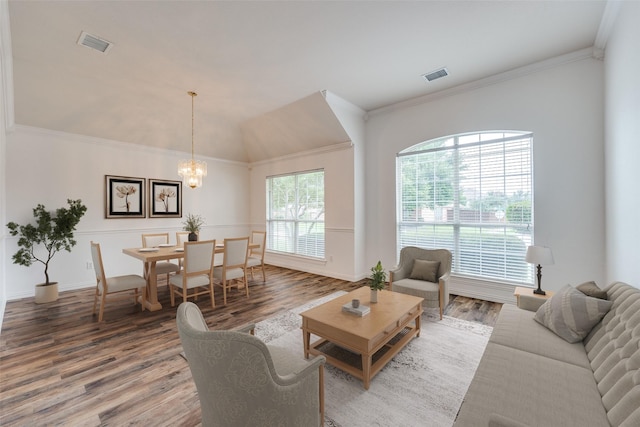 7002 Westover Dr, Rowlett, TX 75089 - living area featuring wood finished floors, a chandelier, and ornamental molding
