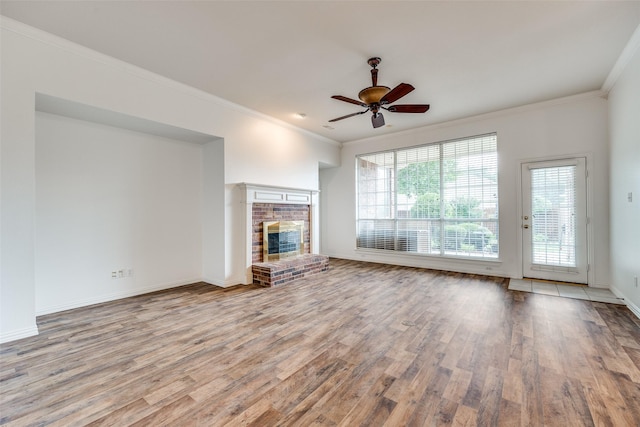 7002 Westover Dr, Rowlett, TX 75089 - unfurnished living room featuring wood finished floors, a brick fireplace, crown molding, ceiling fan, and baseboards