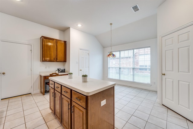 7002 Westover Dr, Rowlett, TX 75089 - kitchen with brown cabinets, light tile patterned flooring, light countertops, vaulted ceiling, and a kitchen island