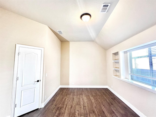 2095 Deckard, Princeton, TX 75407 - bonus room featuring baseboards, dark wood finished floors, built in features, vaulted ceiling, and a textured ceiling