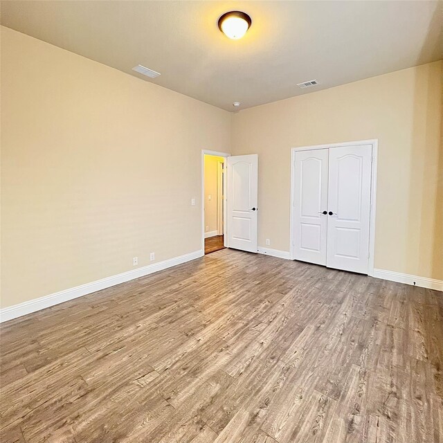 2095 Deckard, Princeton, TX 75407 - unfurnished bedroom featuring wood finished floors, baseboards, and a closet