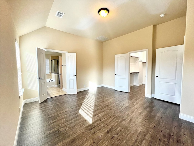 2095 Deckard, Princeton, TX 75407 - unfurnished bedroom with dark wood finished floors, a spacious closet, vaulted ceiling, and baseboards