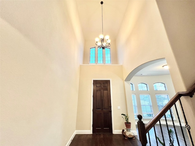 2095 Deckard, Princeton, TX 75407 - foyer entrance featuring a towering ceiling, dark wood-style flooring, arched walkways, a chandelier, and baseboards