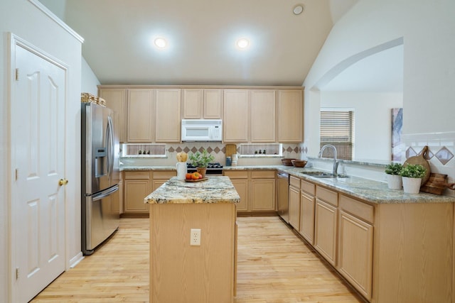 4525 Crooked Ridge Dr, The Colony, TX 75056 - kitchen featuring stainless steel appliances, light brown cabinets, a sink, a center island, and backsplash