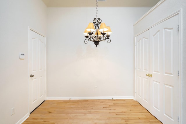 4525 Crooked Ridge Dr, The Colony, TX 75056 - unfurnished dining area featuring a chandelier, light wood-style flooring, and baseboards