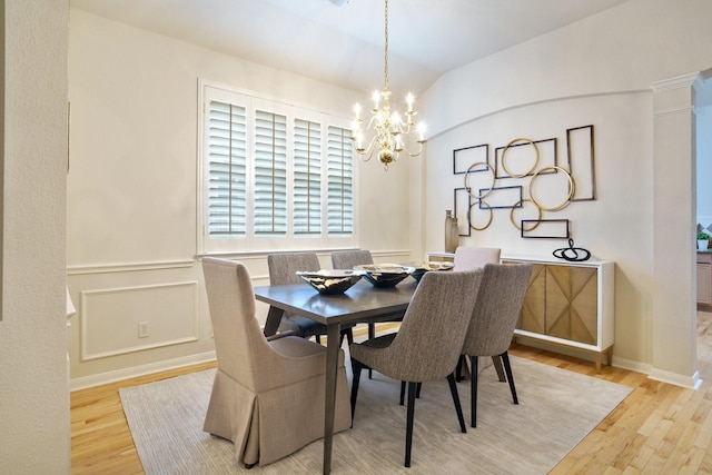 4525 Crooked Ridge Dr, The Colony, TX 75056 - dining room featuring a chandelier, wood finished floors, and wainscoting
