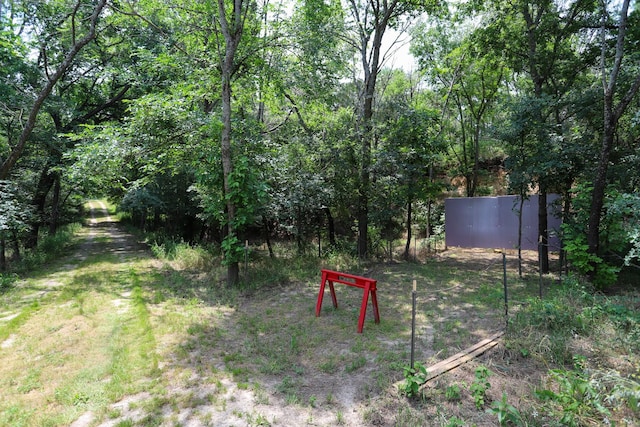 813 Sam Bass Rd, Mcgregor, TX 76657 - view of yard featuring fence and a wooded view
