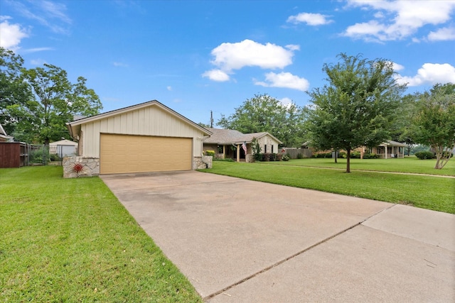1247 Wedgewood Dr, Cleburne, TX 76033 - view of front facade featuring stone siding, a front lawn, concrete driveway, and a garage