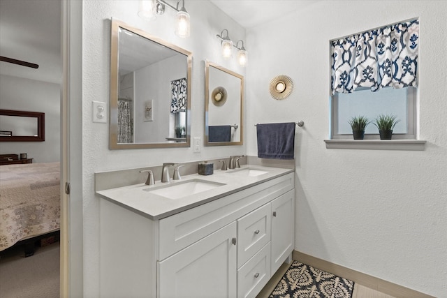 1247 Wedgewood Dr, Cleburne, TX 76033 - ensuite bathroom with double vanity and baseboards
