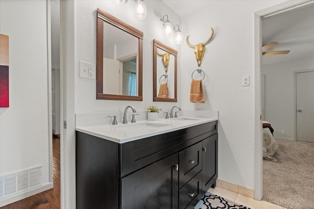 1247 Wedgewood Dr, Cleburne, TX 76033 - bathroom with double vanity, baseboards, and a ceiling fan