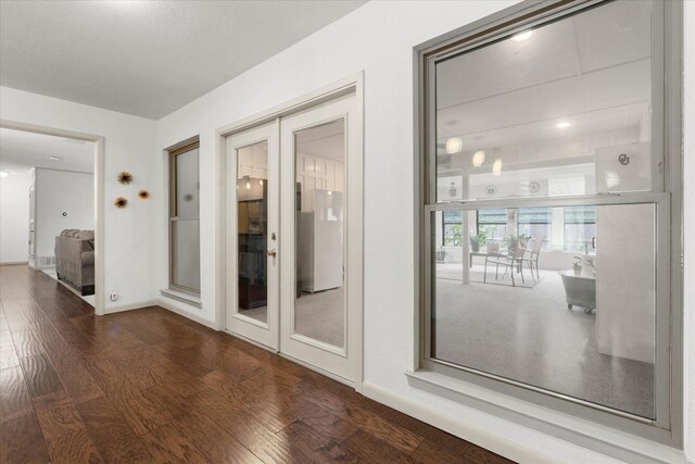 1247 Wedgewood Dr, Cleburne, TX 76033 - empty room with dark wood-type flooring, french doors, and baseboards