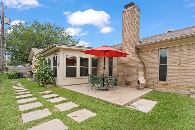1247 Wedgewood Dr, Cleburne, TX 76033 - rear view of house with brick siding, a chimney, and a patio