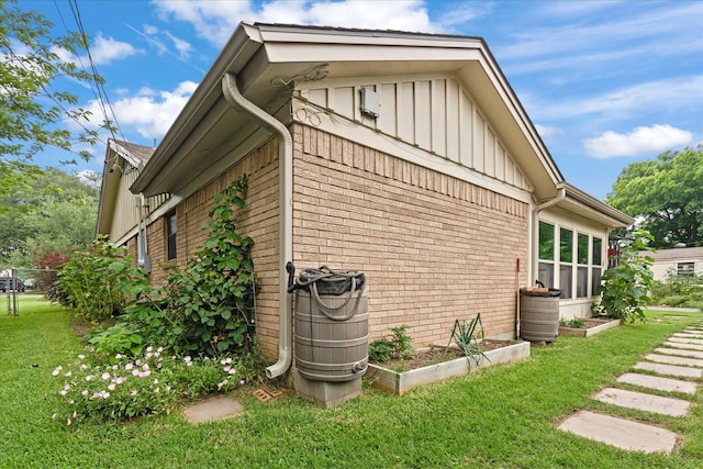 1247 Wedgewood Dr, Cleburne, TX 76033 - view of property exterior featuring brick siding, board and batten siding, and a vegetable garden
