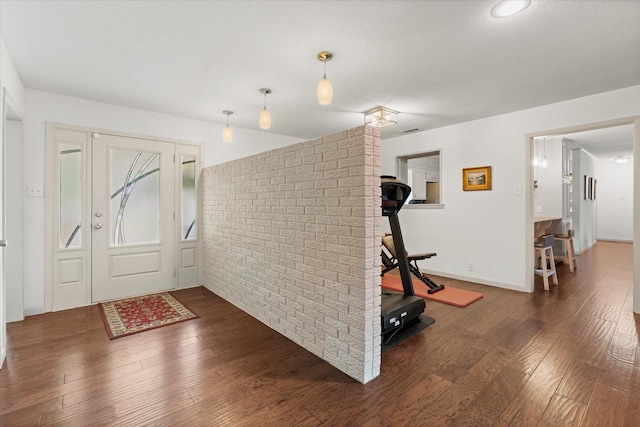 1247 Wedgewood Dr, Cleburne, TX 76033 - entrance foyer featuring wood finished floors and brick wall